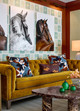 Ozone Wallpaper in Sky imbues the space with soft blue tones and a rhythmic ikat design, providing a serene backdrop for equestrian artwork and rich brown accents.